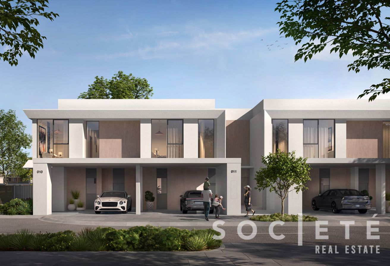 Modern two-story townhouses with driveways, parked cars, and pedestrians near the entrances in a residential development.